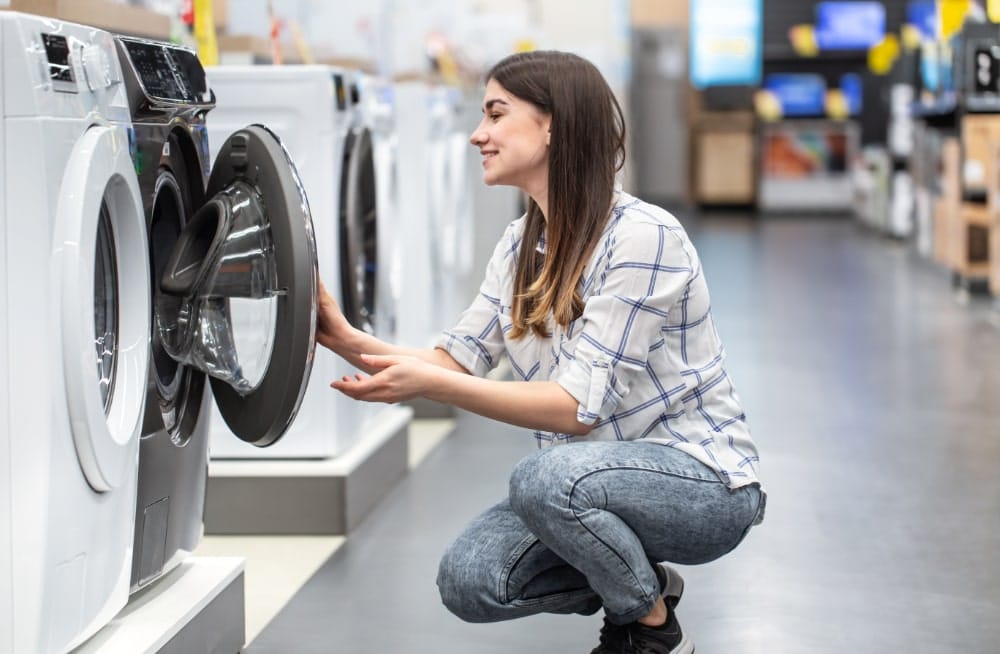 a young woman in a store chooses a washing machine 2021 09 02 08 00 29 utc min